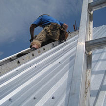 Man on roof installing steel